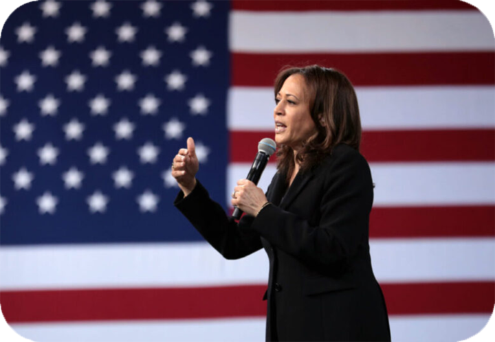 Kamala Harris speaking in front of an American flag
