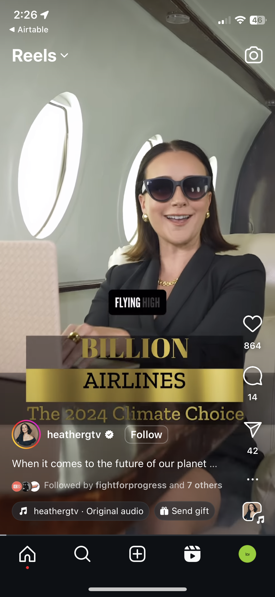 A screenshot of an Instagram post. A woman sits in an airline with a sign that reads "Billion Airlines: The 2024 Climate Choice"